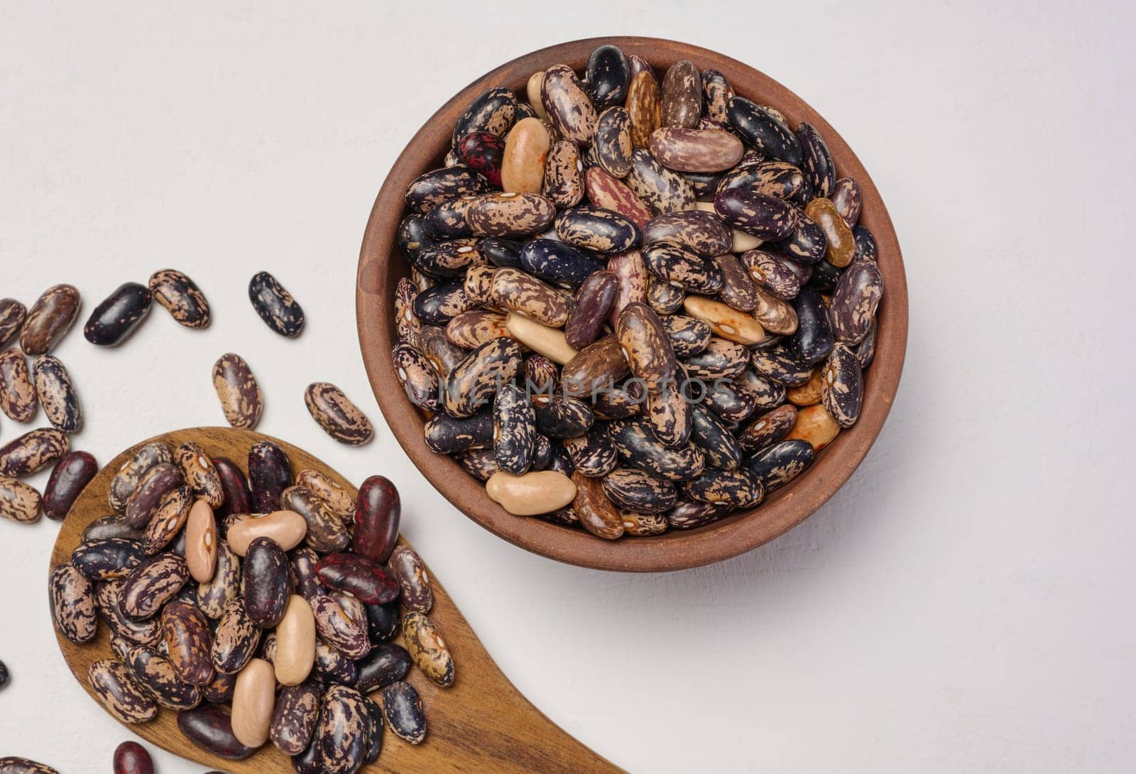 Raw red beans in a plate on the table, top view.
