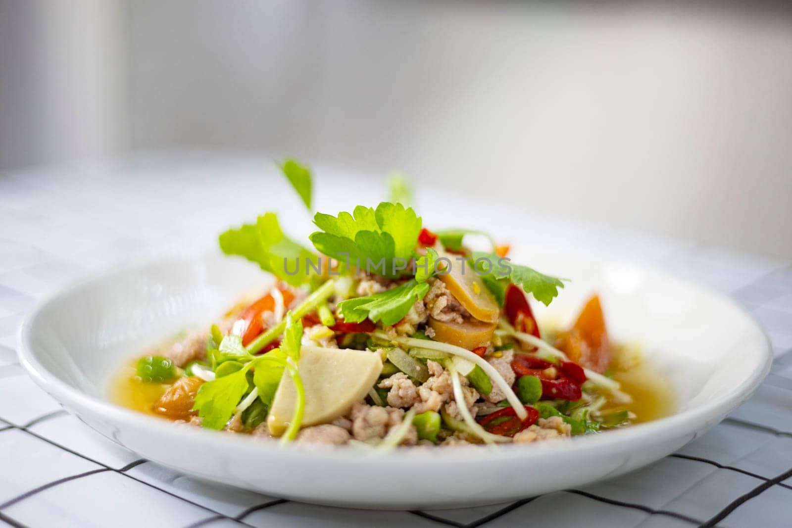 Thai spicy mix salad with sausage and mixed vegetable on the table.
