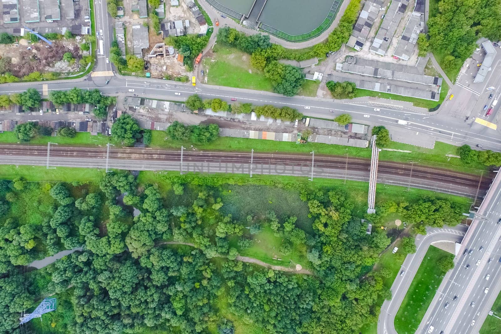 Top view of the urban lake. Lake, road in the city and parking