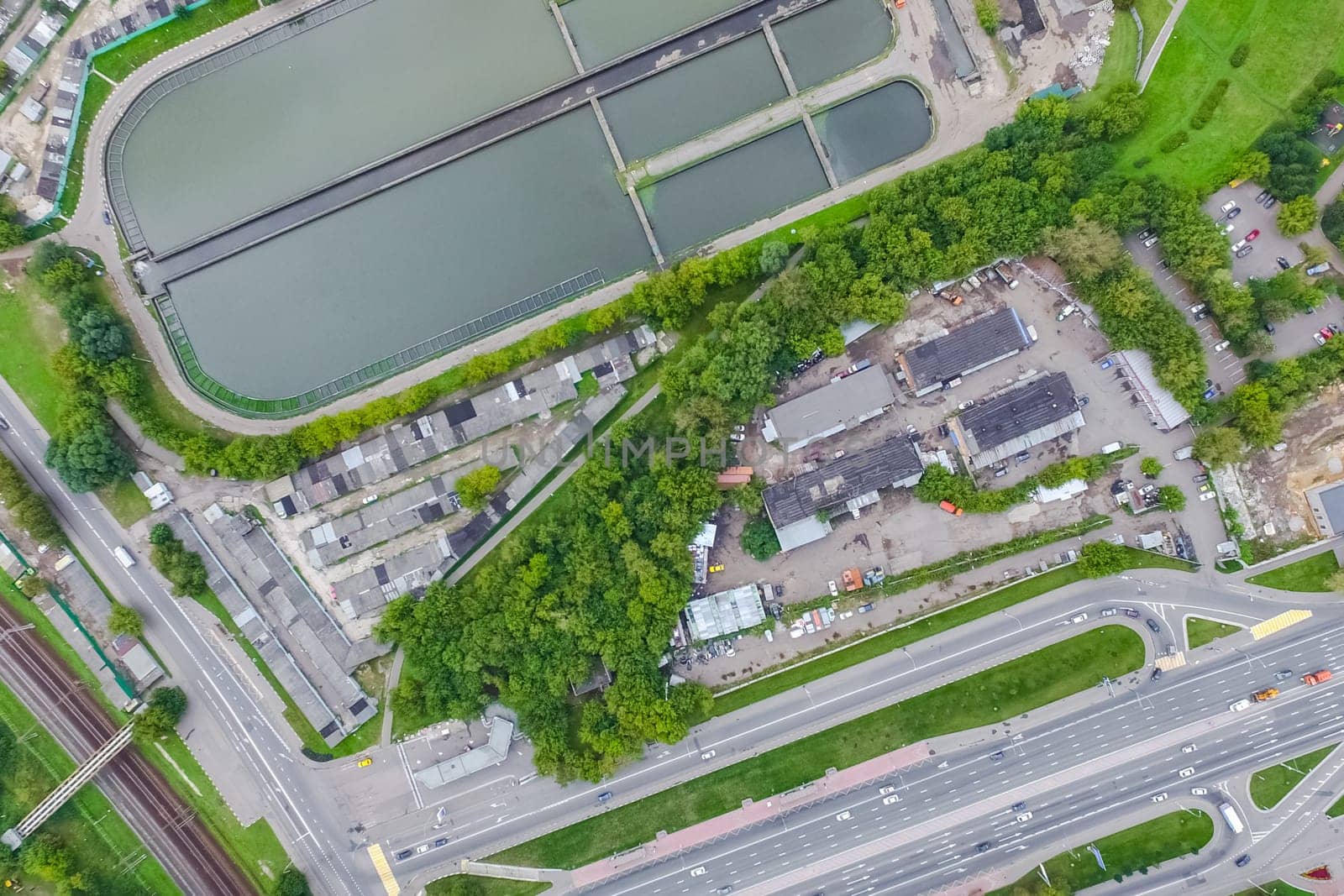 Top view of the urban lake. Lake, road in the city and parking