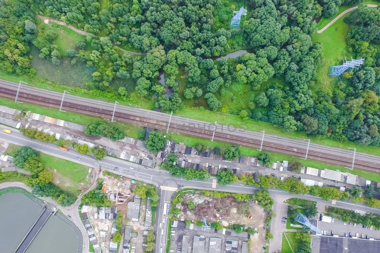 Top view of the urban lake. Lake, road in the city and parking