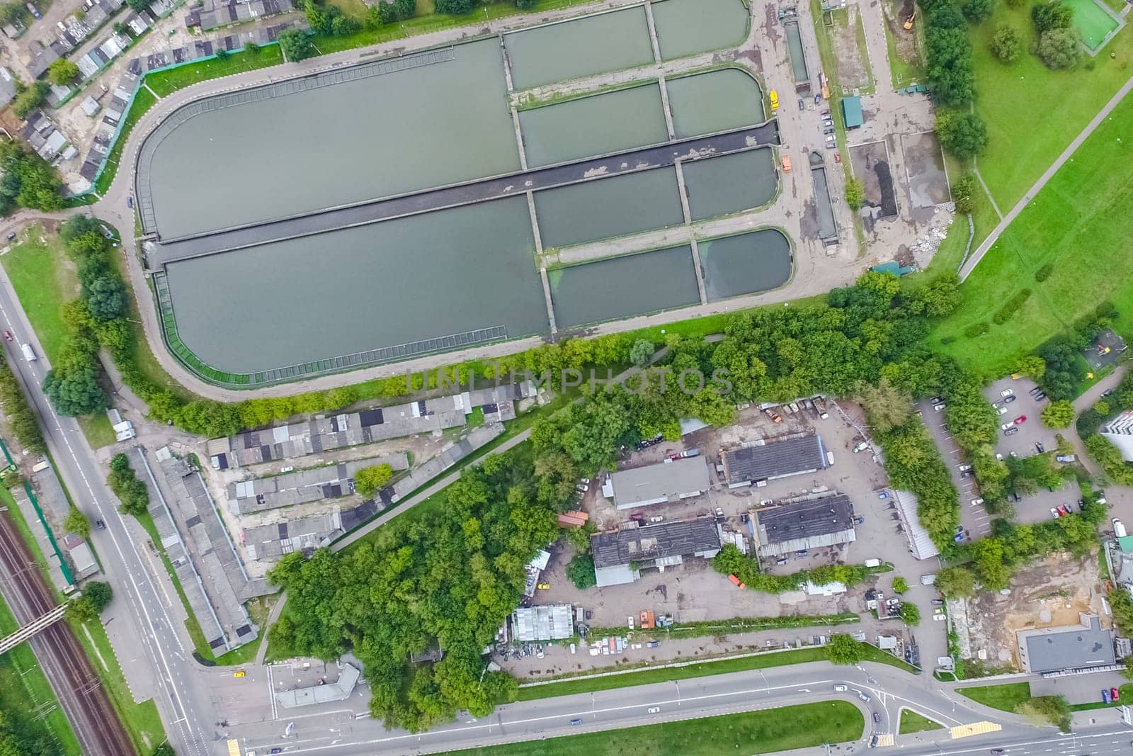 Top view of the urban lake. Lake, road in the city and parking