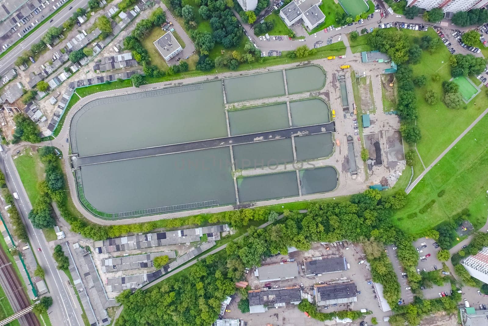 Top view of the urban lake. Lake, road in the city and parking