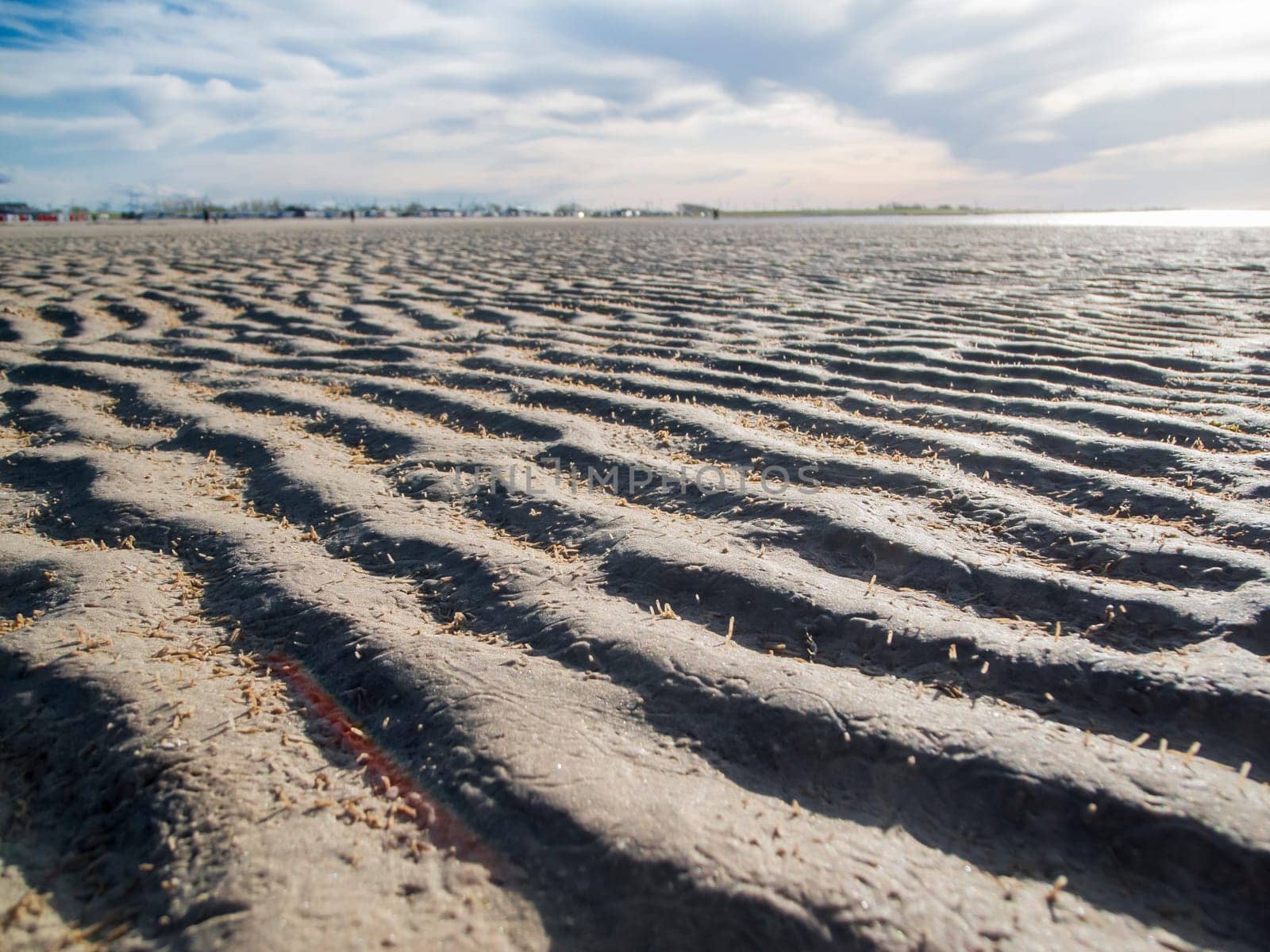 Flat wide-angle view over the dried out and wavy mudflats in East Frisia near Bensersiel.