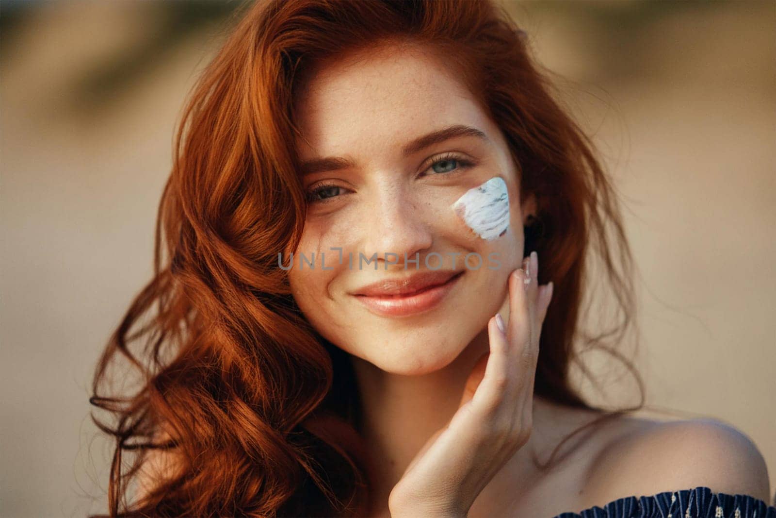 Happy smiling woman with sunscreen smear on her face. Sunscreen cosmetics with SPF in summer.