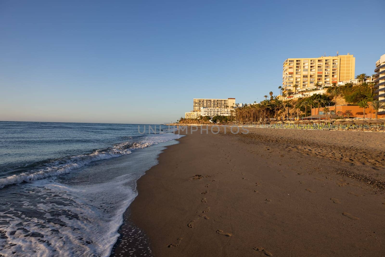 View of Bajondillo Beach and hotels in Torremolinos at sunrise. Costa del Sol, Spain.