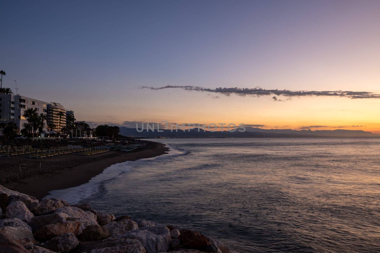 View of Bajondillo beach in Torremolinos just before sunrise. Costa del Sol, Spain
