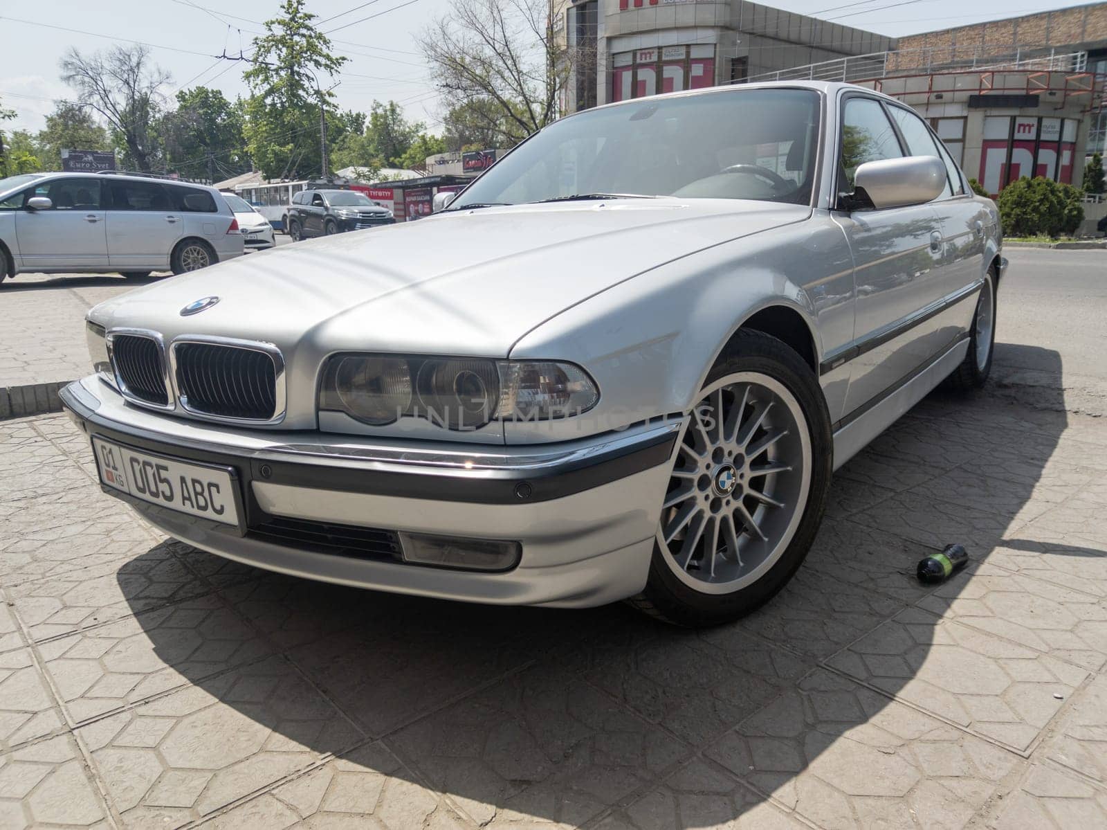 perfectly saved silver BMW 740i E38 on sunny summer streets of Bishkek, Kyrgyzstan - June 9, 2023