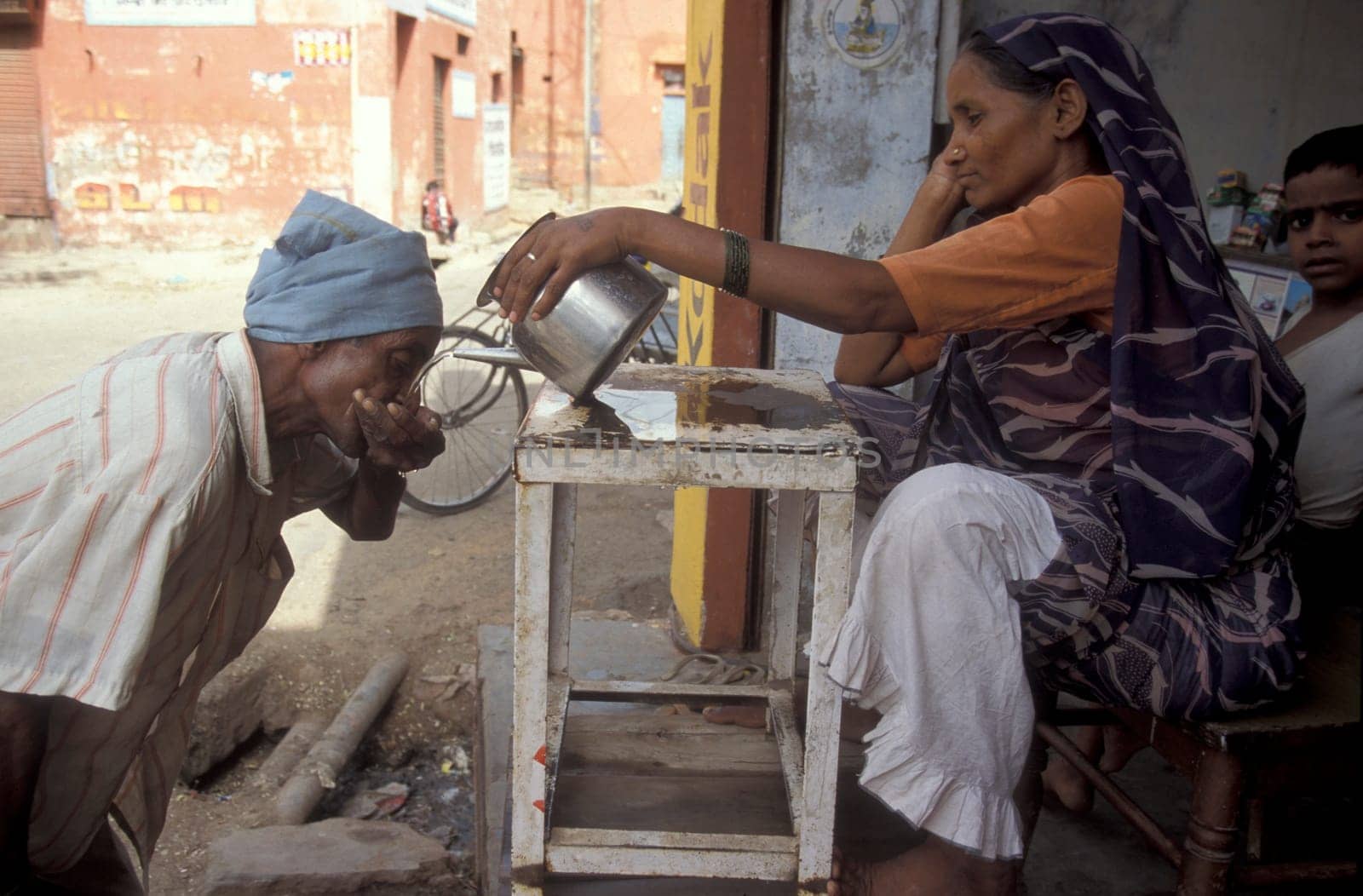 a free public water station for dursty people at a shop by very hot weather in the city of Khajurao in Province Madhya Pradesh in India.  India, Khajurao, April, 1998