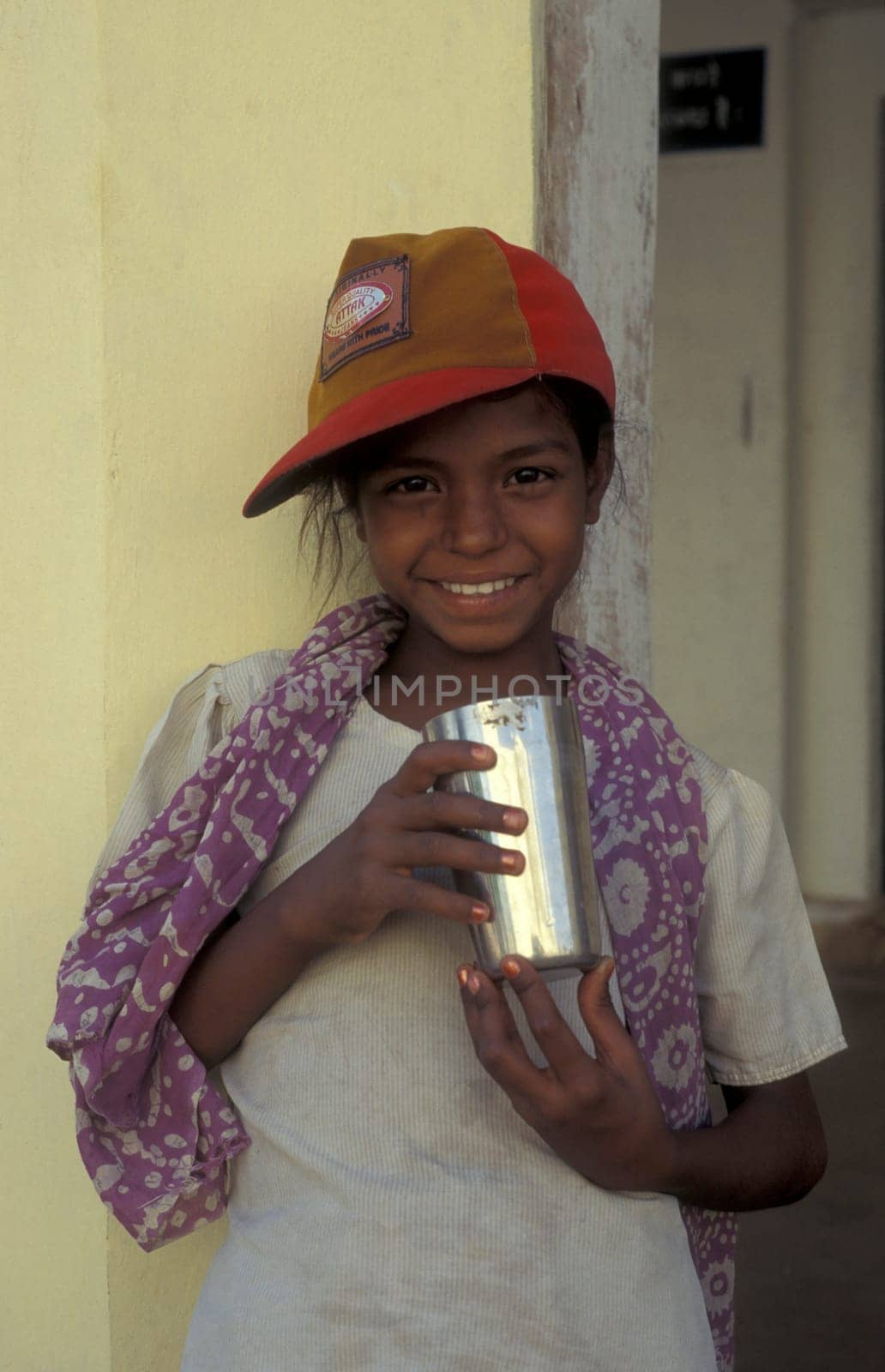 a women at a free public water station for dursty people at a shop by very hot weather in the city of Khajurao in Province Madhya Pradesh in India.  India, Khajurao, April, 1998