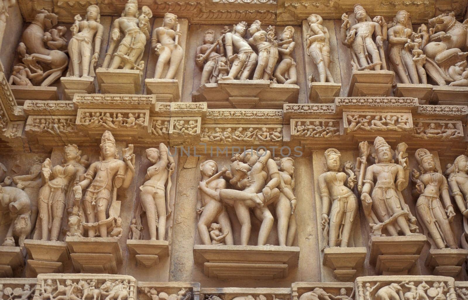 Erotic Sculptures at the erotic Temple or Hindu Temple of Kandarija Mahadeva Temple in the city of Khajurao in Province Madhya Pradesh in India.  India, Khajurao, April, 1998