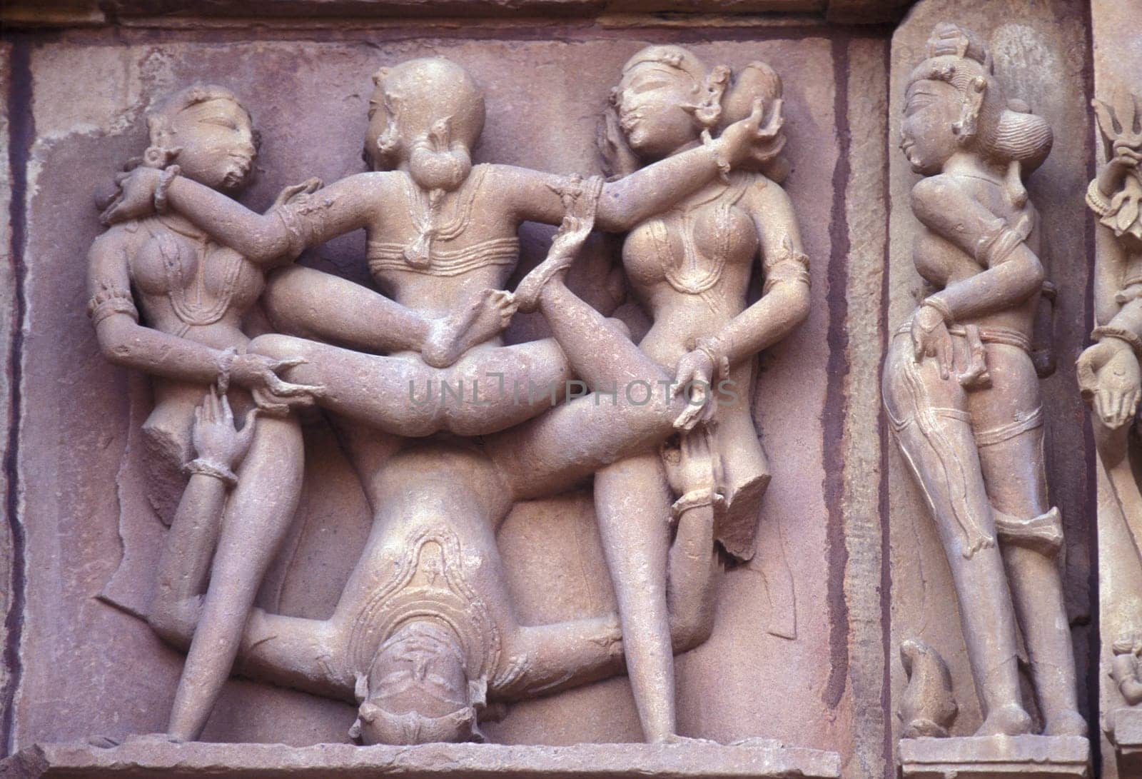 Erotic Sculptures at the erotic Temple or Hindu Temple of Kandarija Mahadeva Temple in the city of Khajurao in Province Madhya Pradesh in India.  India, Khajurao, April, 1998