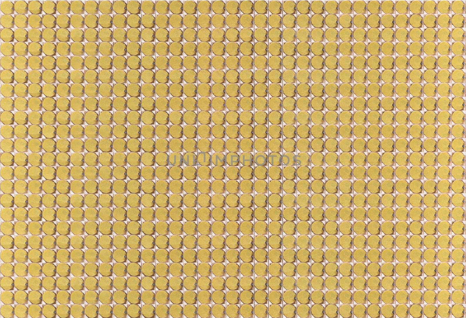 Analog mechanism composed of numerous rows of golden circular cells meticulously aligned to create a visually appealing pattern ideal for industrial design contexts to highlight precision and elegance