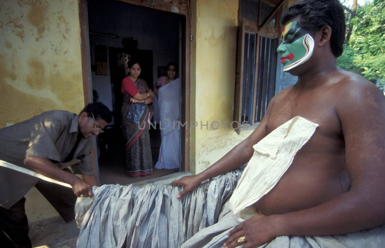 Artists at preparations get ready of a Kathakali Dance Group at a authentic training in the city of Kochi or Cochin in the Province Kerala in India.  India, Cochin, April, 1998