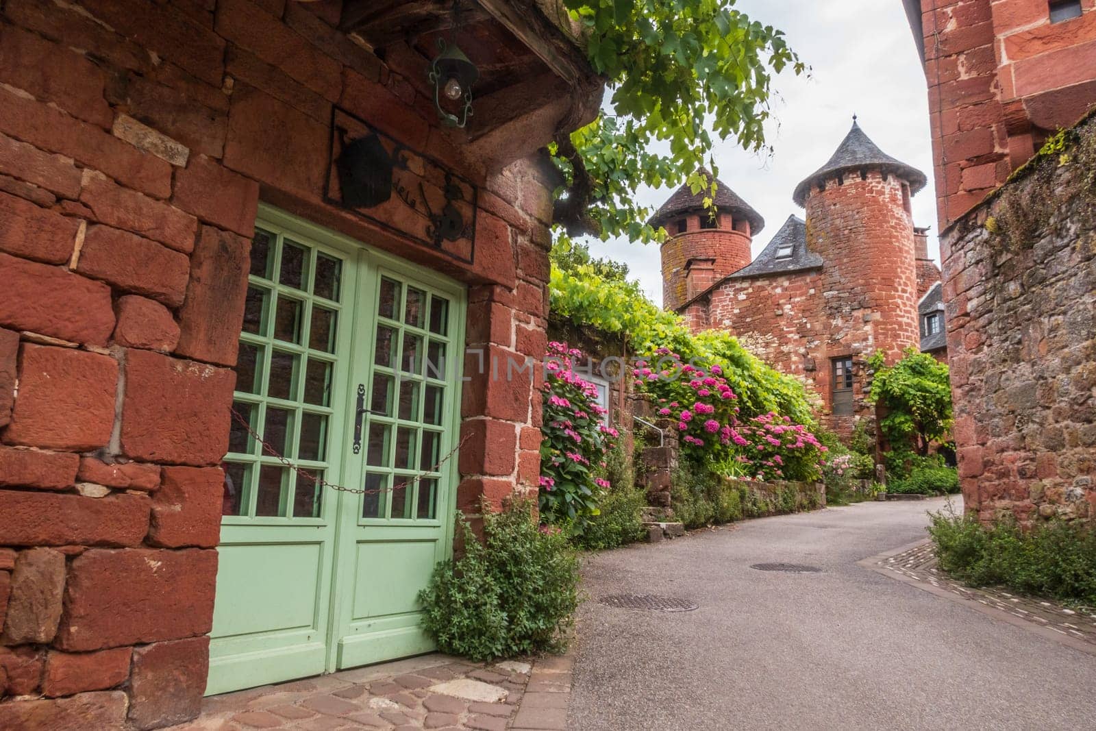 Red houses seen from the street in Collonges-la-Rouge, one of the most beautiful villages in France, Corrèze