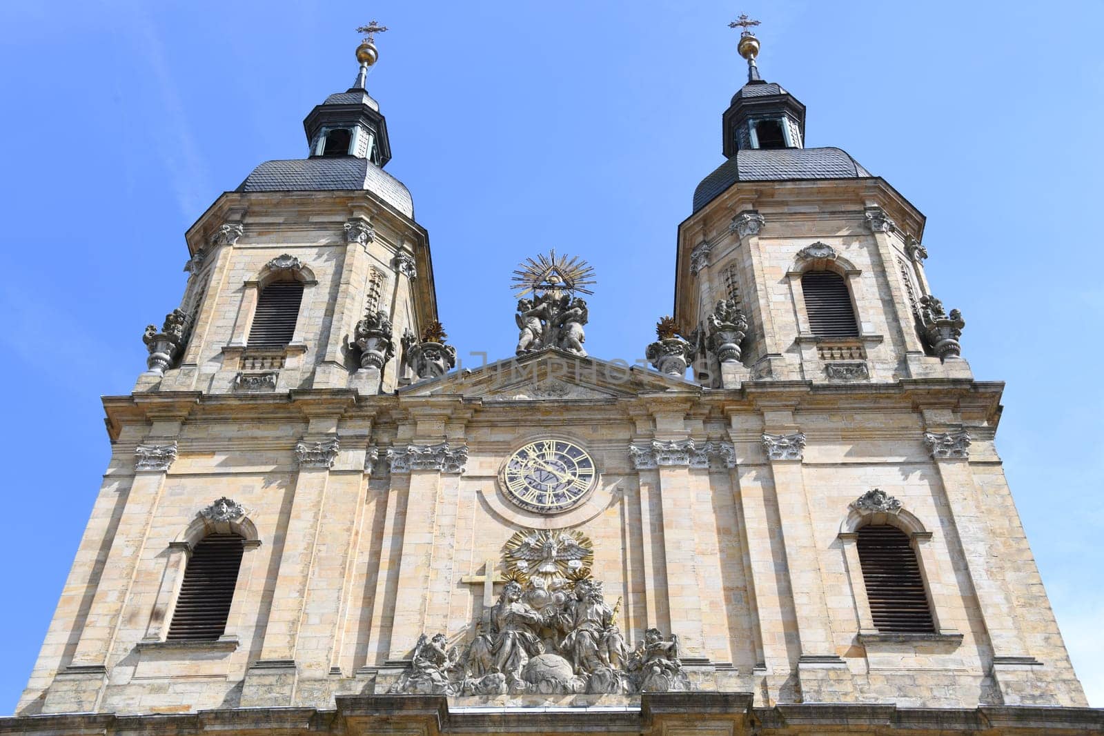 The main portal of the basilica in 91327 Gößweinstein in the Archdiocese of Bamberg in Franconian Switzerland is dedicated to the Holy Trinity. The pilgrimage church was built by Balthasar Neumann. Flags. Goessweinstein.