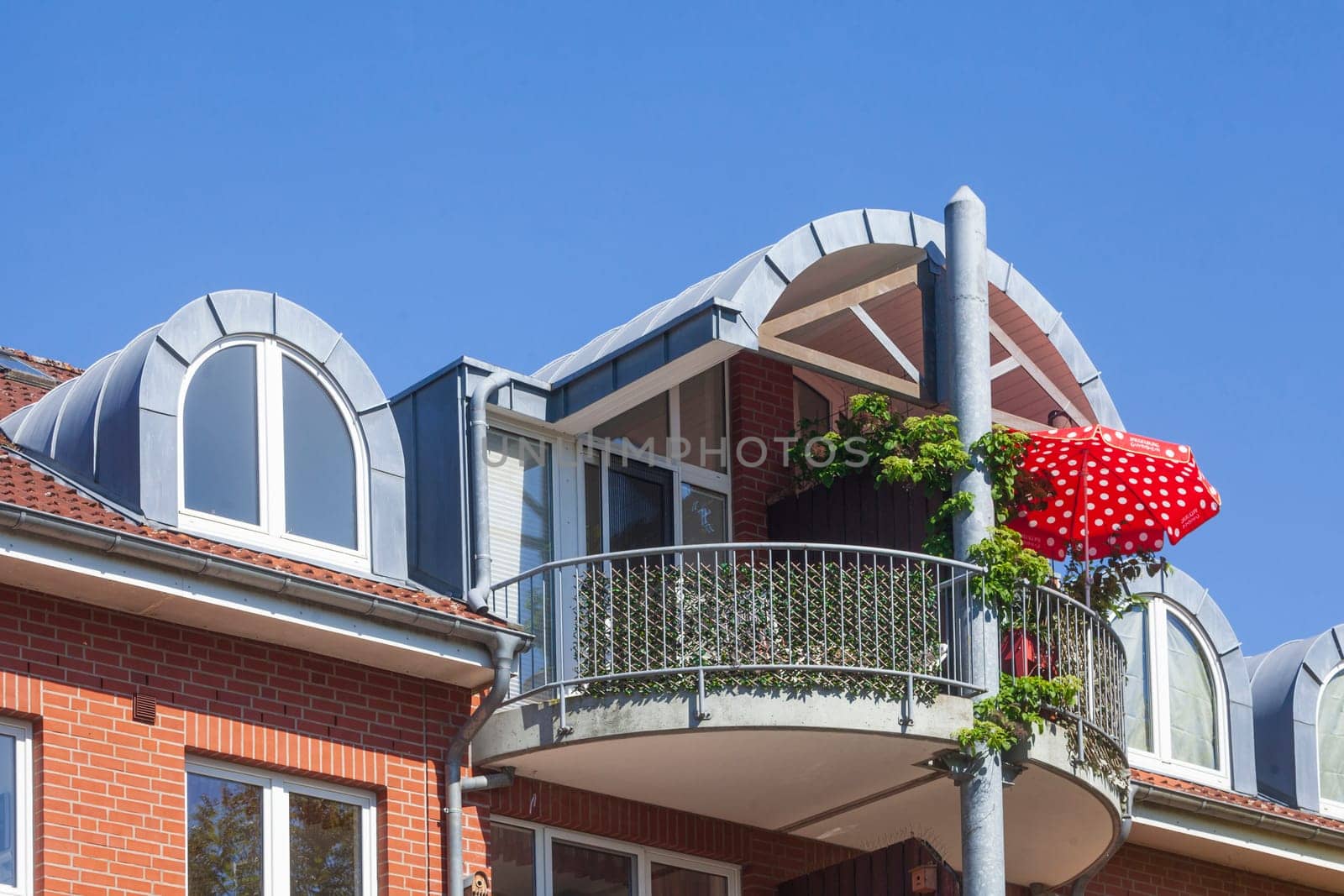 Modern brick residential building with balcony and sunshade, Buxtehude, Lower Saxony, Germany
