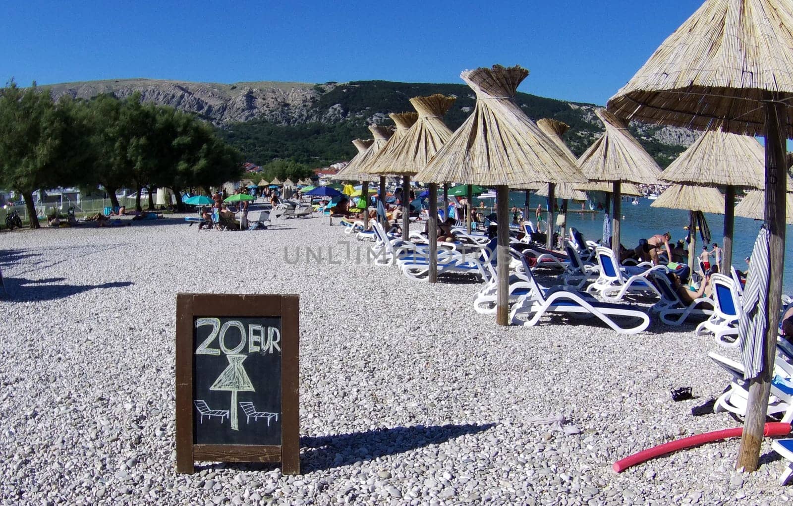 Quite nicely expensive: Sun lounger for 20 euros daily fee on the beach of Baska/island of Krk  Theme picture Croatia / Hrvatska / Croatia 2024