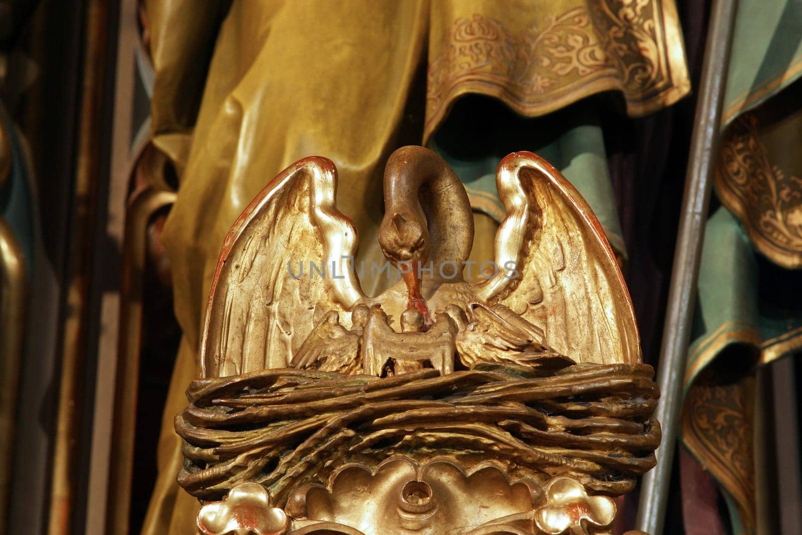 A pelican feeds its young, a Christian symbol, statue on the main altar in the parish church of Saint Joseph in Grubisno Polje, Croatia
