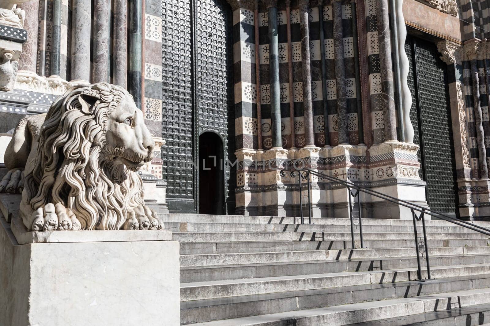 Genoa, Italy - 28 December 2023: the guard lion at the entrance of the Duomo - most important church of the town