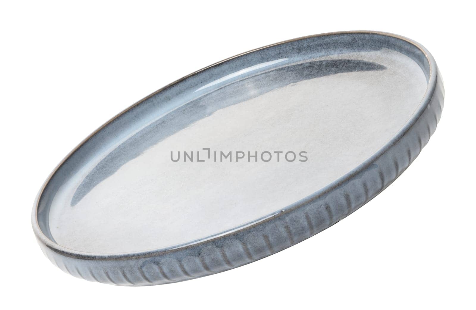 Empty blue round ceramic plate at an angle on isolated background