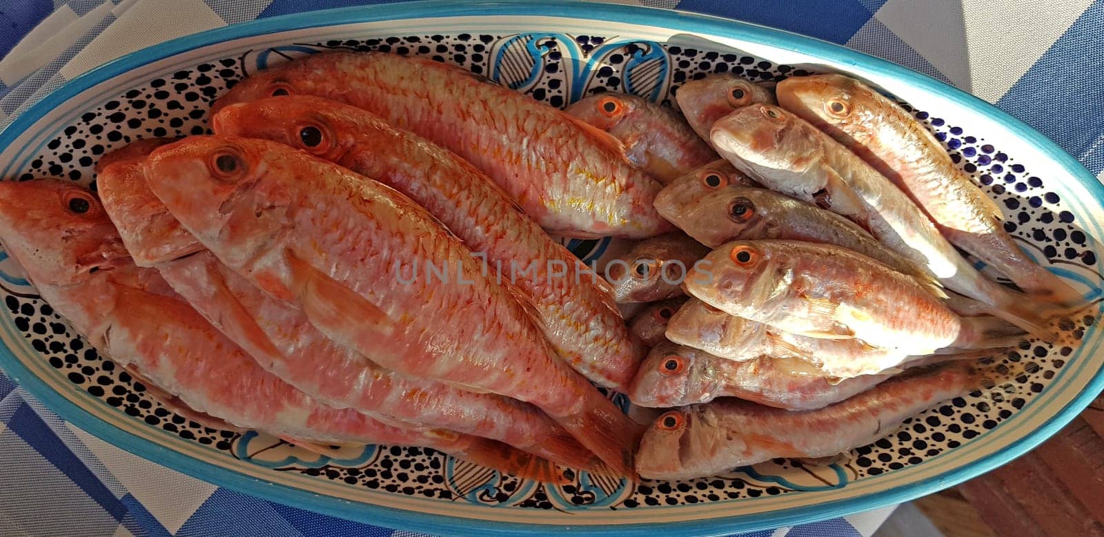 Fresh red mullets fishes stacked in a row on ice trays at the market stock instant prints background high quality down loadings