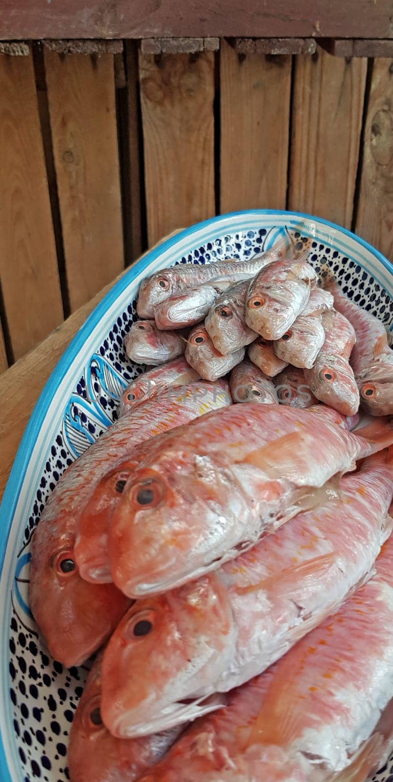 Fresh red mullets fishes stacked in a row on ice trays at the market stock instant prints background high quality down loadings