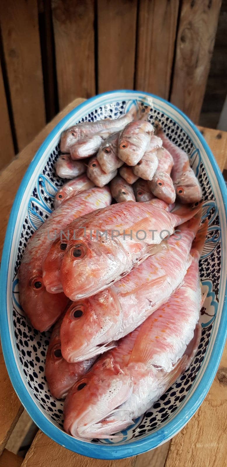 Fresh red mullets fishes stacked in a row on ice trays at the market stock instant prints background high quality down loadings