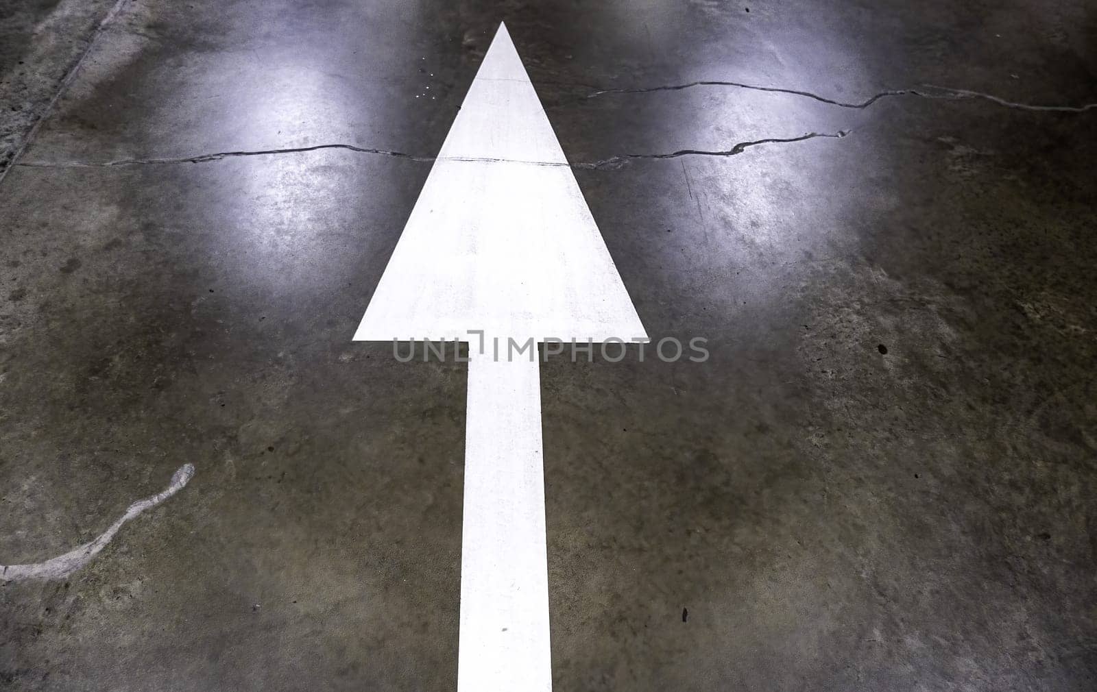 Detail of direction arrow for vehicles in a parking lot