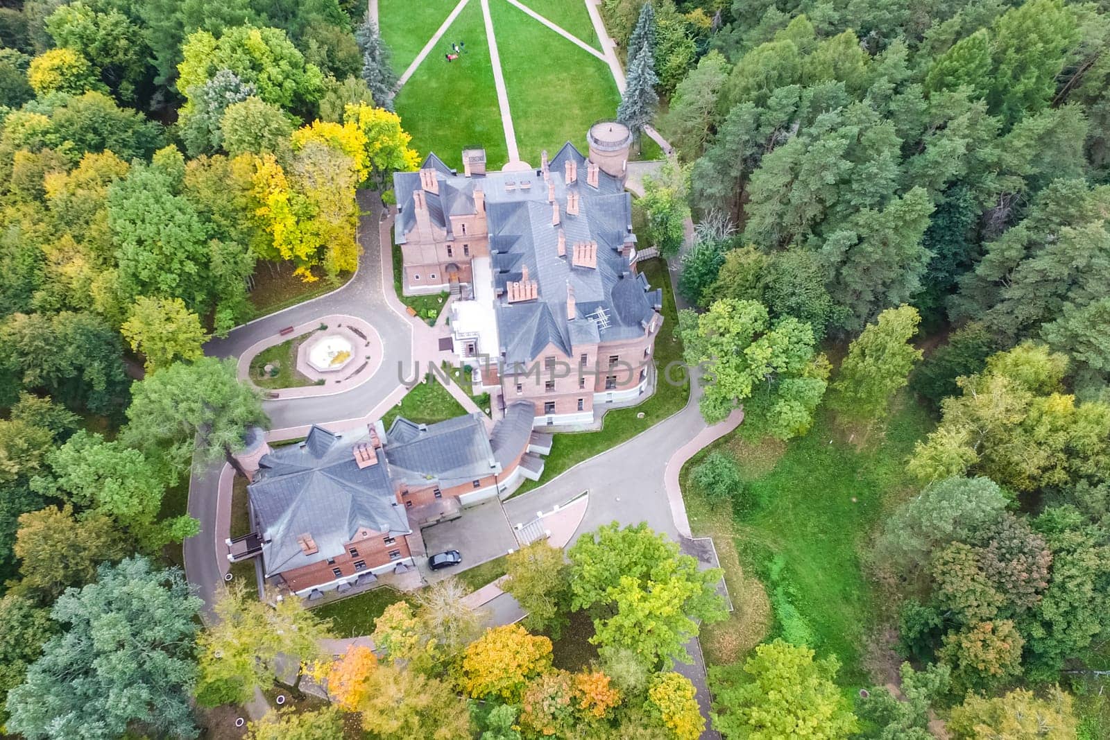 Castle in Moscow in the park. A modern Moscow castle surrounded by trees