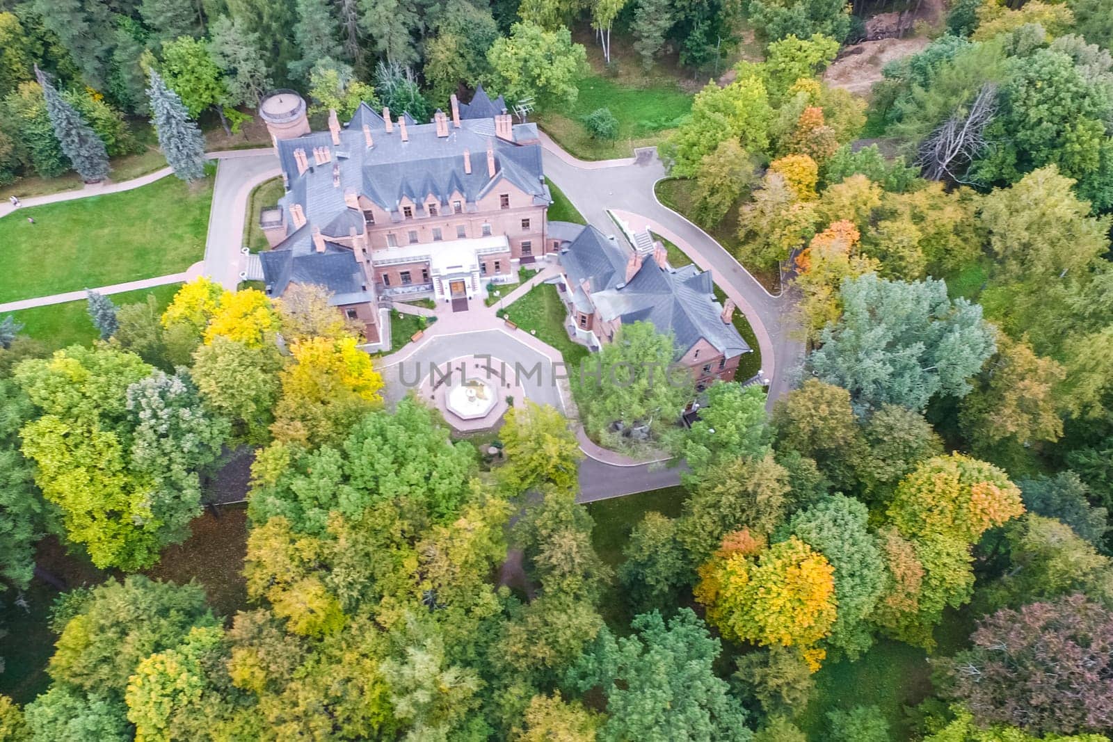 Castle in Moscow in the park. A modern Moscow castle surrounded by trees