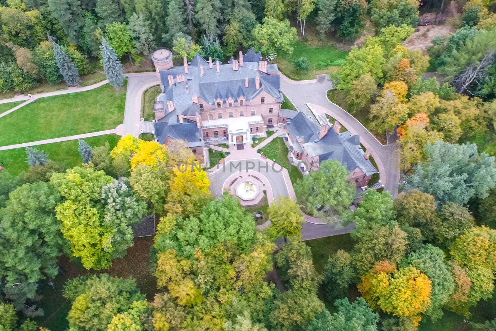Castle in Moscow in the park. A modern Moscow castle surrounded by trees