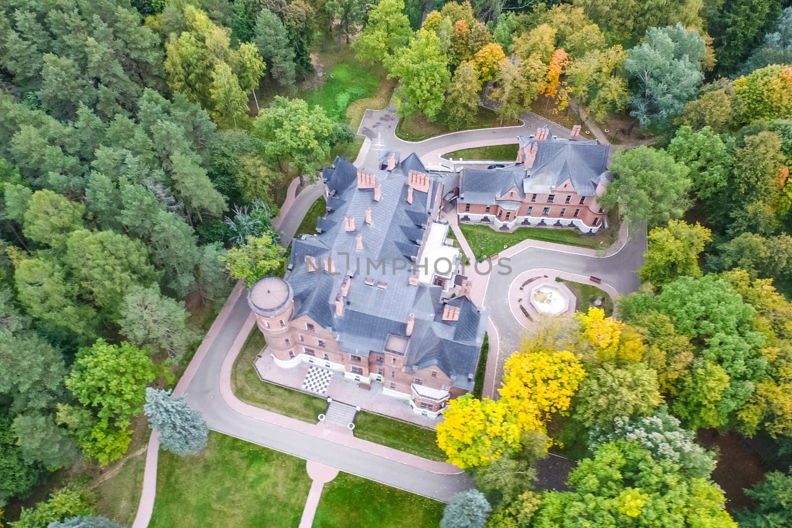 Castle in Moscow in the park. A modern Moscow castle surrounded by trees