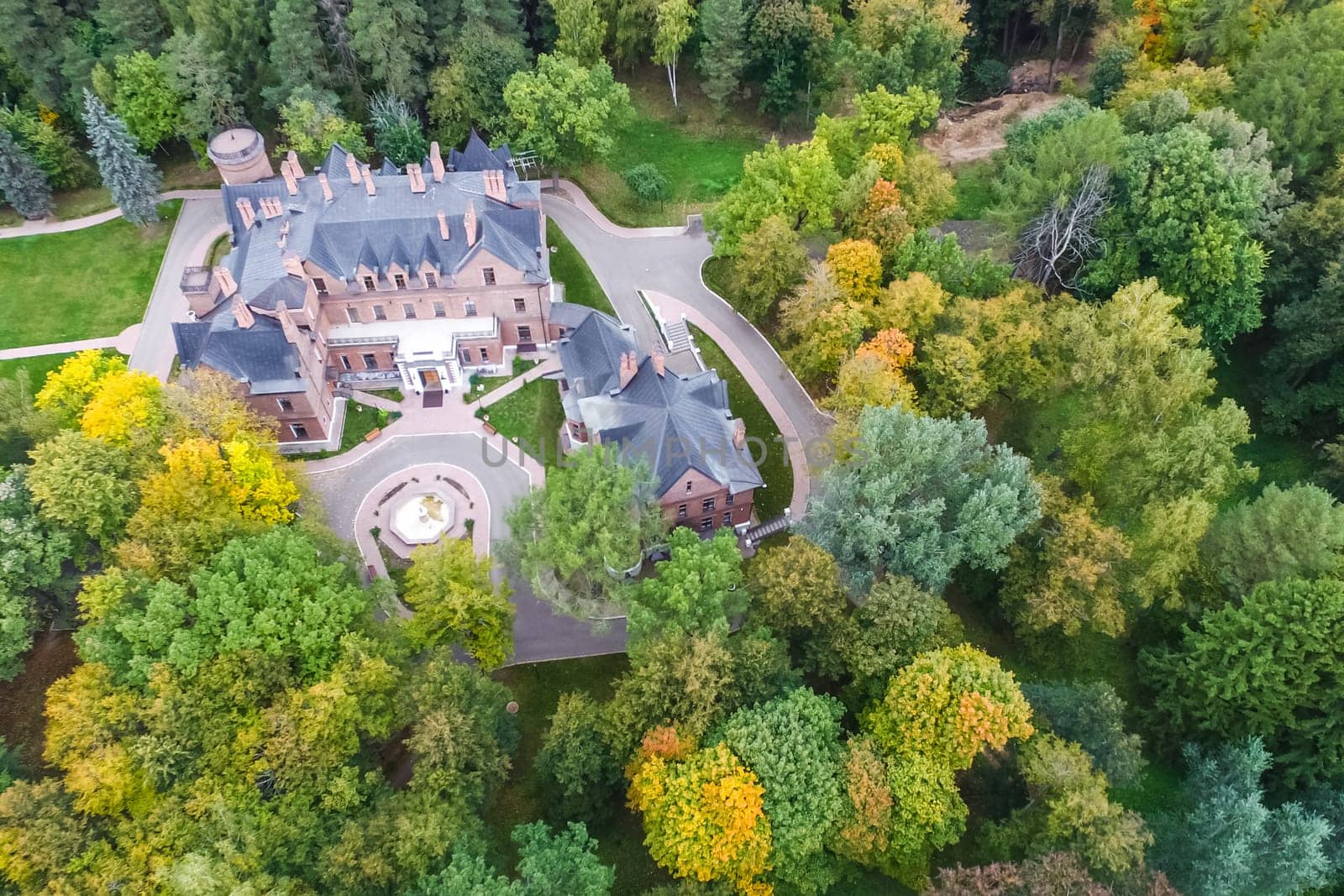 Castle in Moscow in the park. A modern Moscow castle surrounded by trees