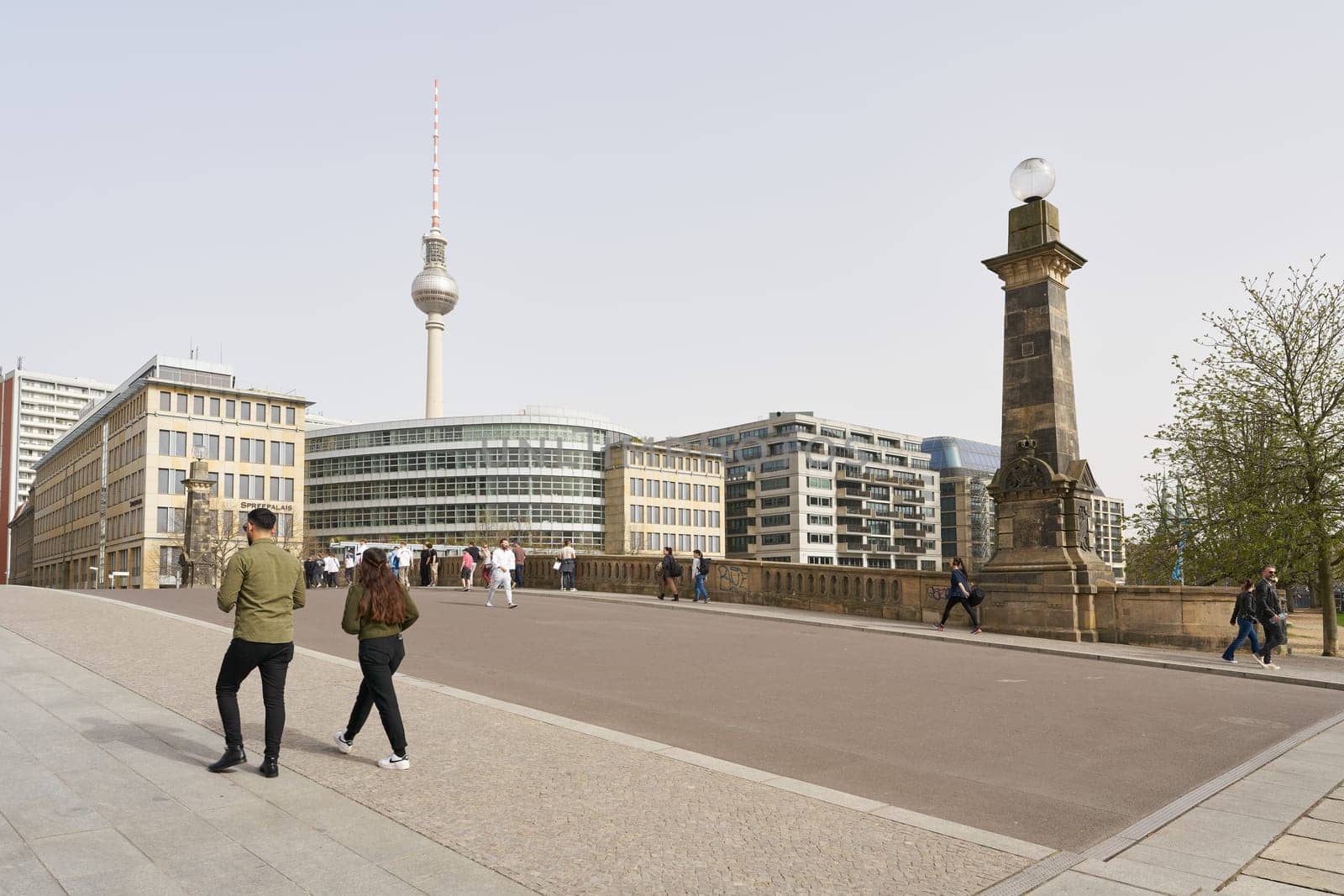Walkers on the Friedrichsbrücke in the Berlin-Mitte district. The television tower in the background.