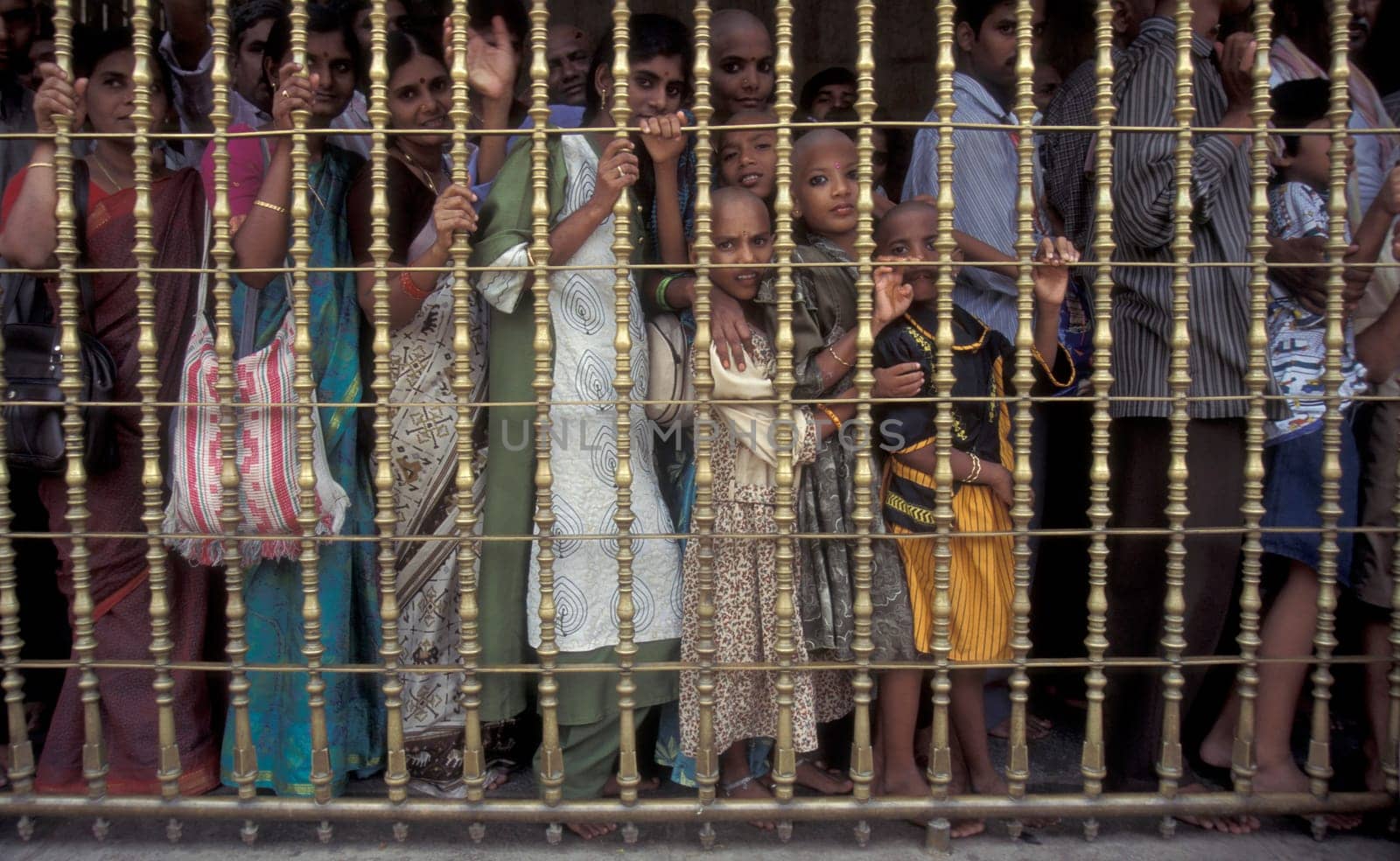 People stand in line at the entrance at the Meenakshi Amman Temple in the city of Madurai in the Province Tamil Nadu in India.  India, Madurai, April, 1998
