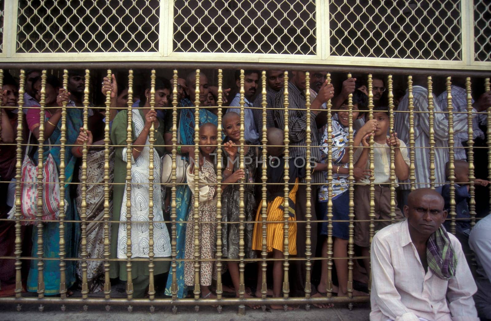 People stand in line at the entrance at the Meenakshi Amman Temple in the city of Madurai in the Province Tamil Nadu in India.  India, Madurai, April, 1998
