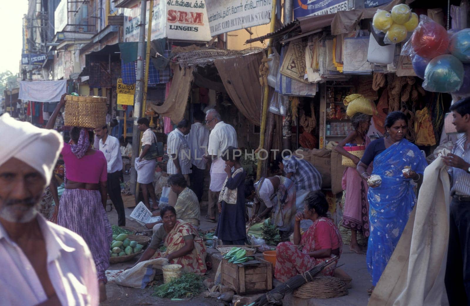 people in a Market street in the city of Madurai in the Province Tamil Nadu in India.  India, Madurai, April, 1998