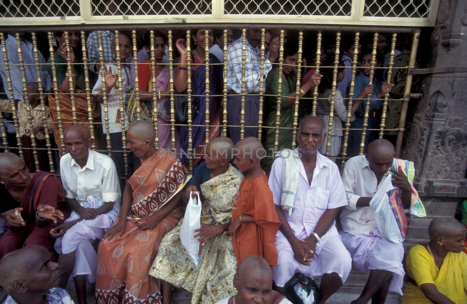 People stand in line at the entrance at the Meenakshi Amman Temple in the city of Madurai in the Province Tamil Nadu in India.  India, Madurai, April, 1998
