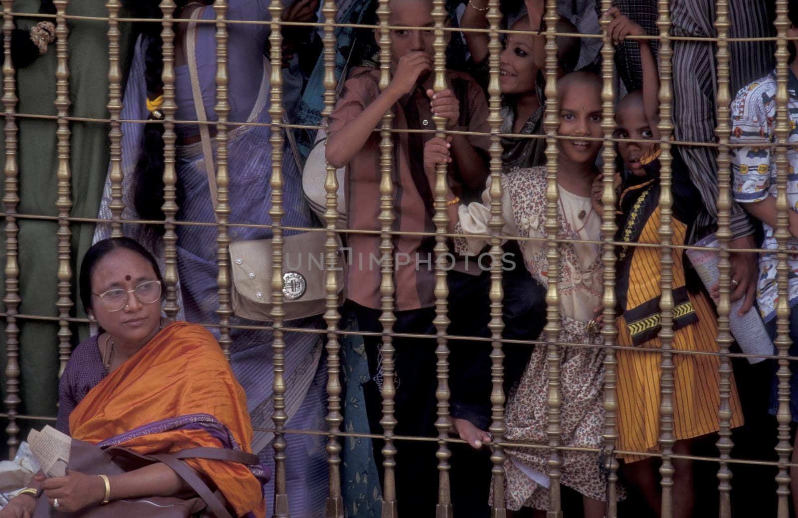 People stand in line at the entrance at the Meenakshi Amman Temple in the city of Madurai in the Province Tamil Nadu in India.  India, Madurai, April, 1998