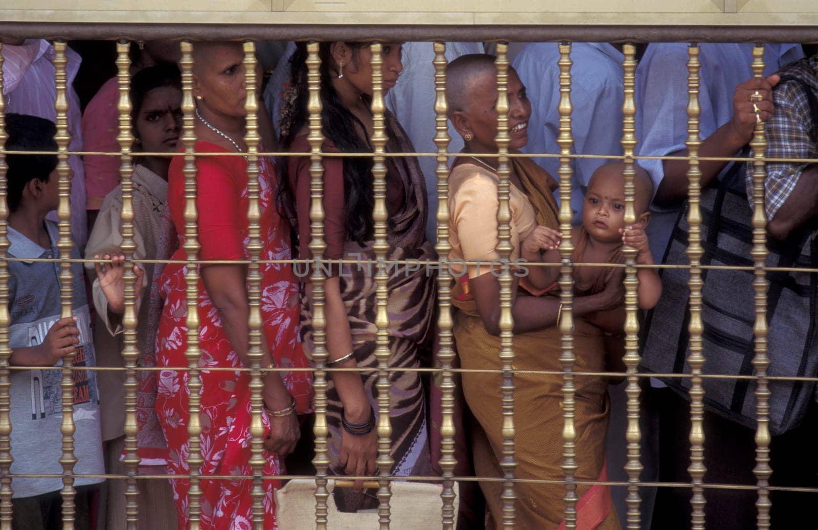 People stand in line at the entrance at the Meenakshi Amman Temple in the city of Madurai in the Province Tamil Nadu in India.  India, Madurai, April, 1998