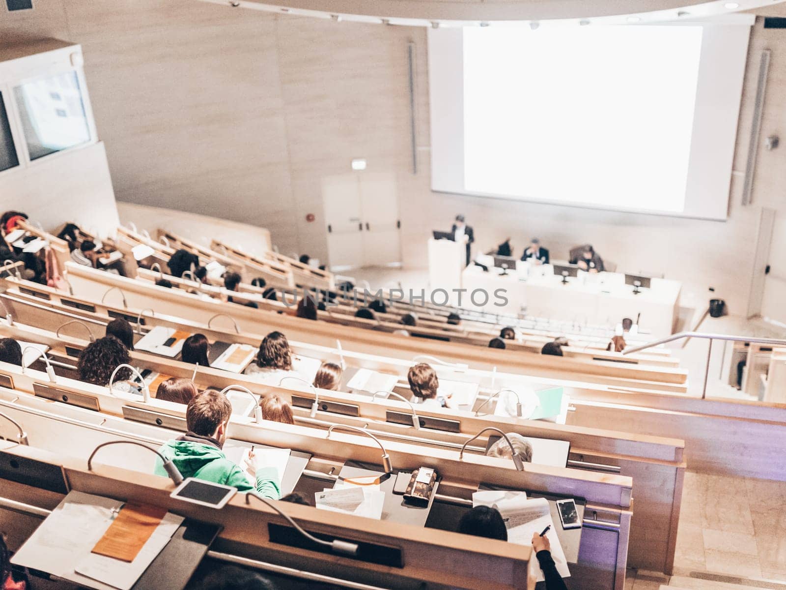 Conference and Presentation. Audience at the conference hall. Business and Entrepreneurship. Faculty lecture and workshop. Audience in the lecture hall. Academic education. Student making notes.