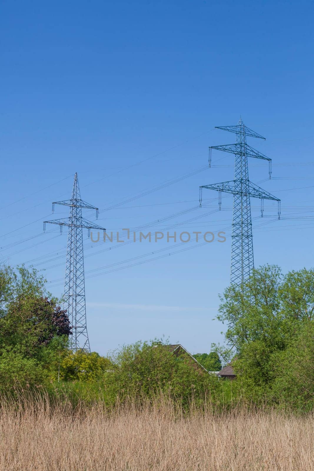 Electricity pylons on the River Este, Buxtehude, Lower Saxony, Germany