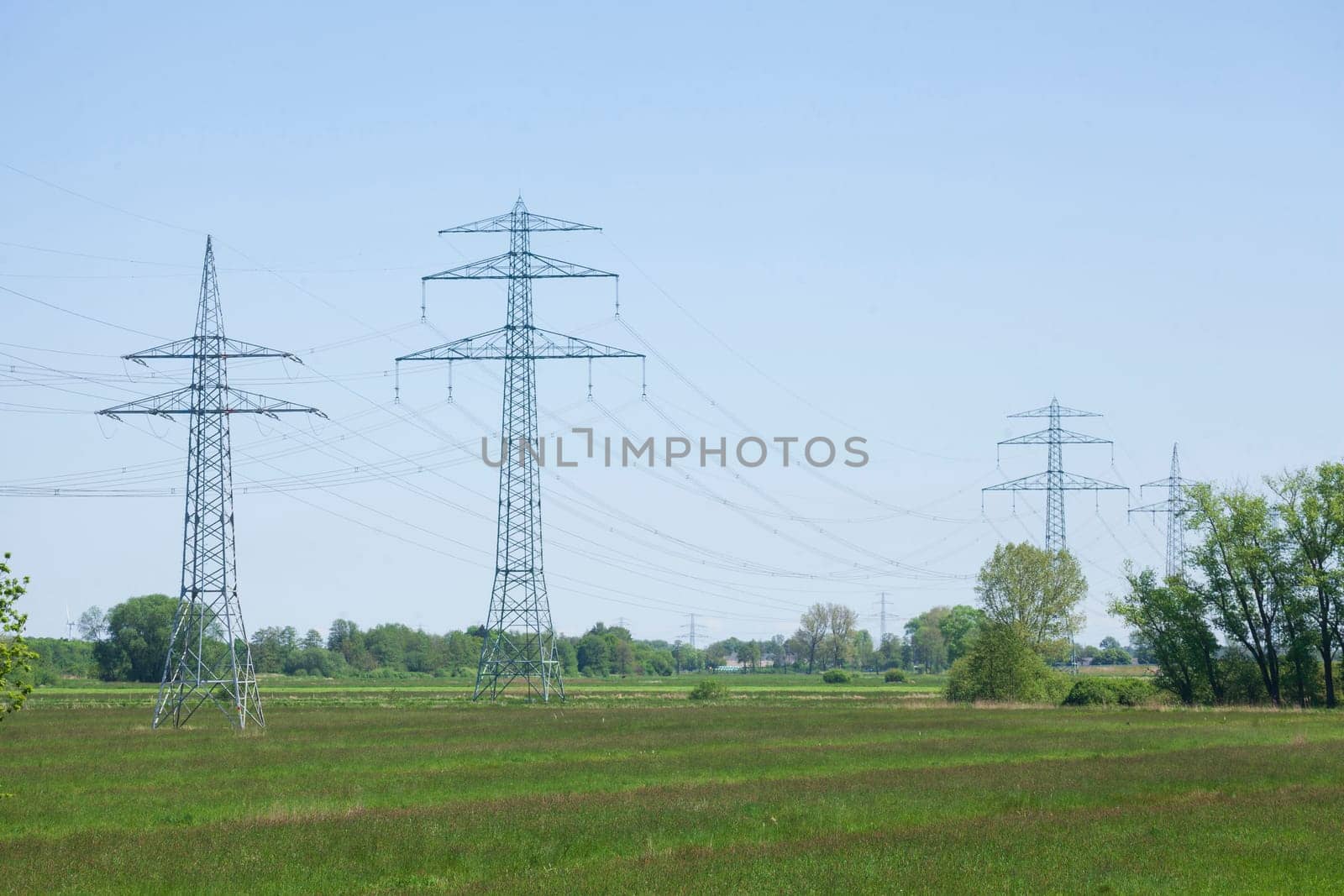 Electricity pylons on the River Este, Buxtehude, Lower Saxony, Germany
