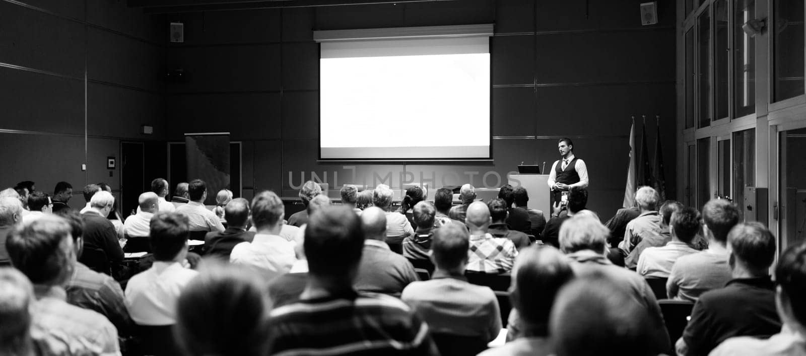 Speaker Giving a Talk at Business Meeting. Audience in the conference hall. Business and Entrepreneurship concept. Black and white.