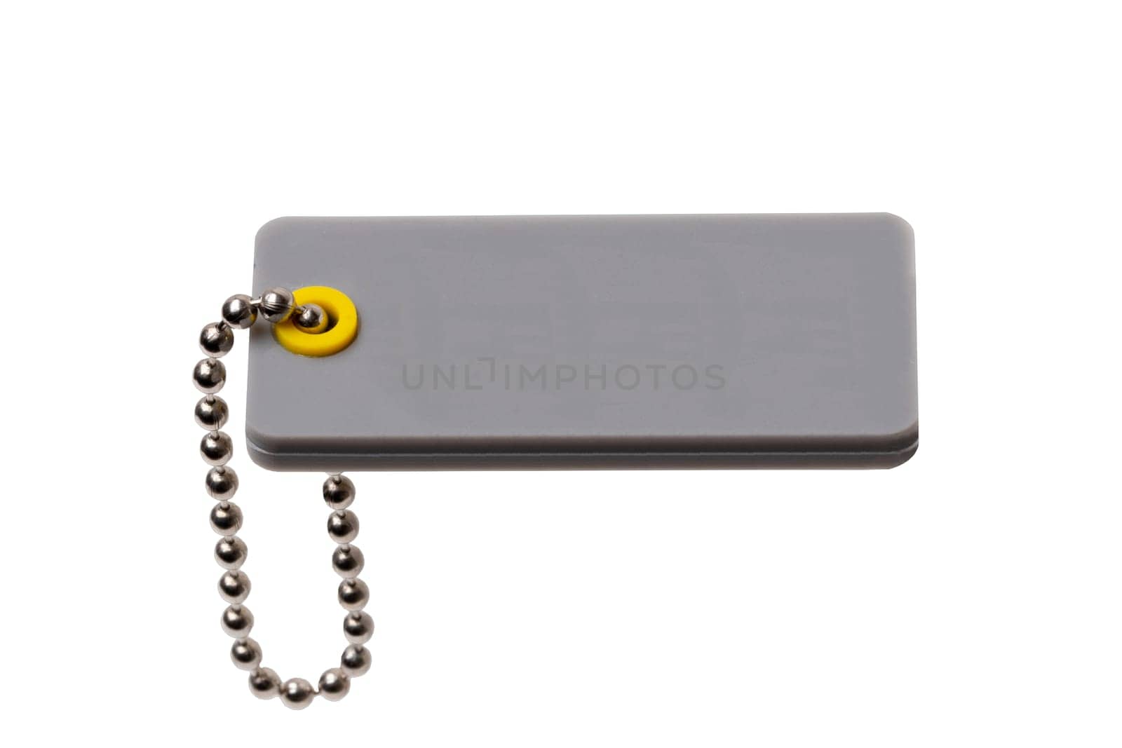 Blank gray plastic tag with chain isolated on a white background. Price or gift tag. Adress label. Clipping path. Space. Macro.