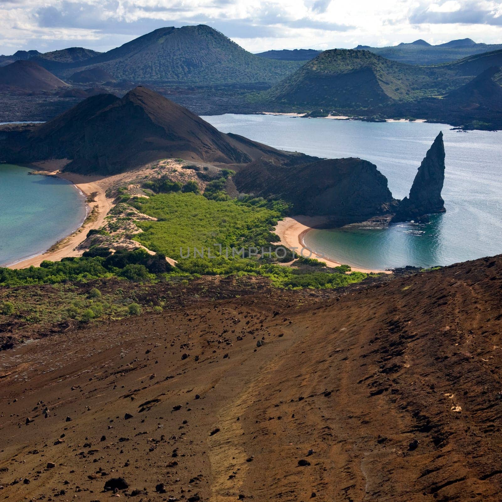 Pinnacle Rock and Volcanic landscape of cinder cones and lava fields on the island of Bartolome in the Galapagos Islands - Ecuador