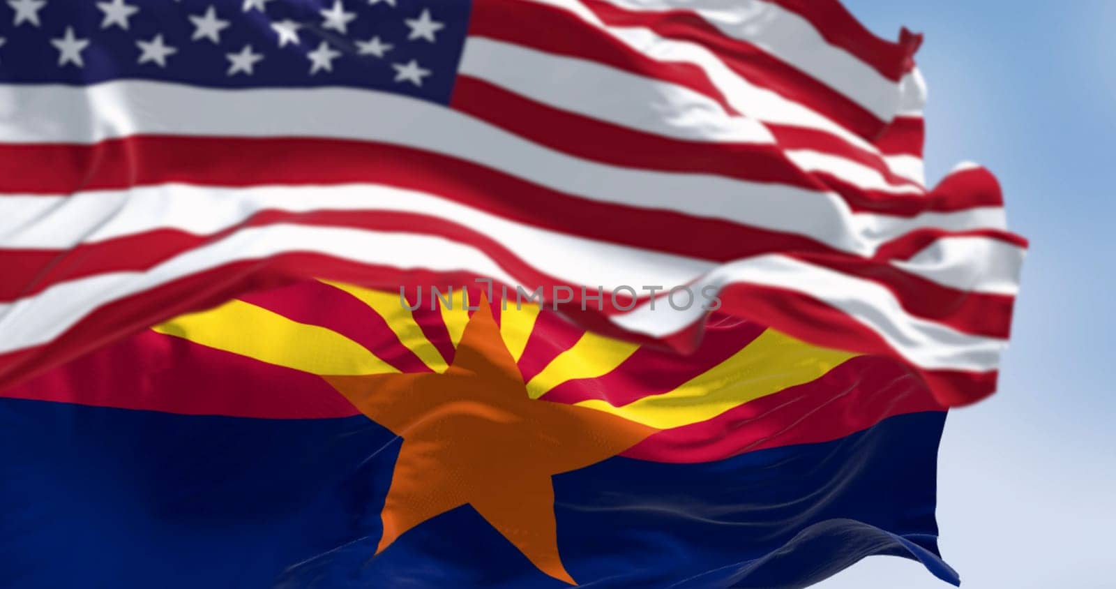 The flags of Arizona and United States waving in the wind on a clear day. Arizona is a state in the Southwestern US. US federate state. 3d illustration render. Selective focus. Fluttering textile