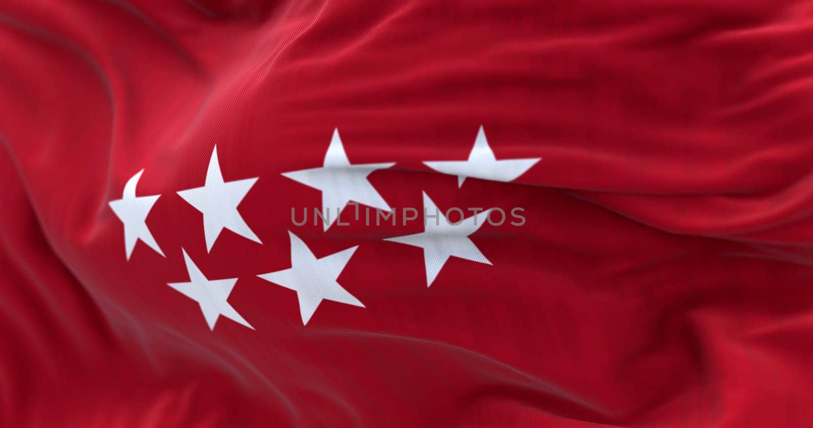 Detail of the Community of Madrid flag waving in the wind. Crimson red with seven silver five-pointed stars. 3d illustration render. Selective focus. Fluttering fabric
