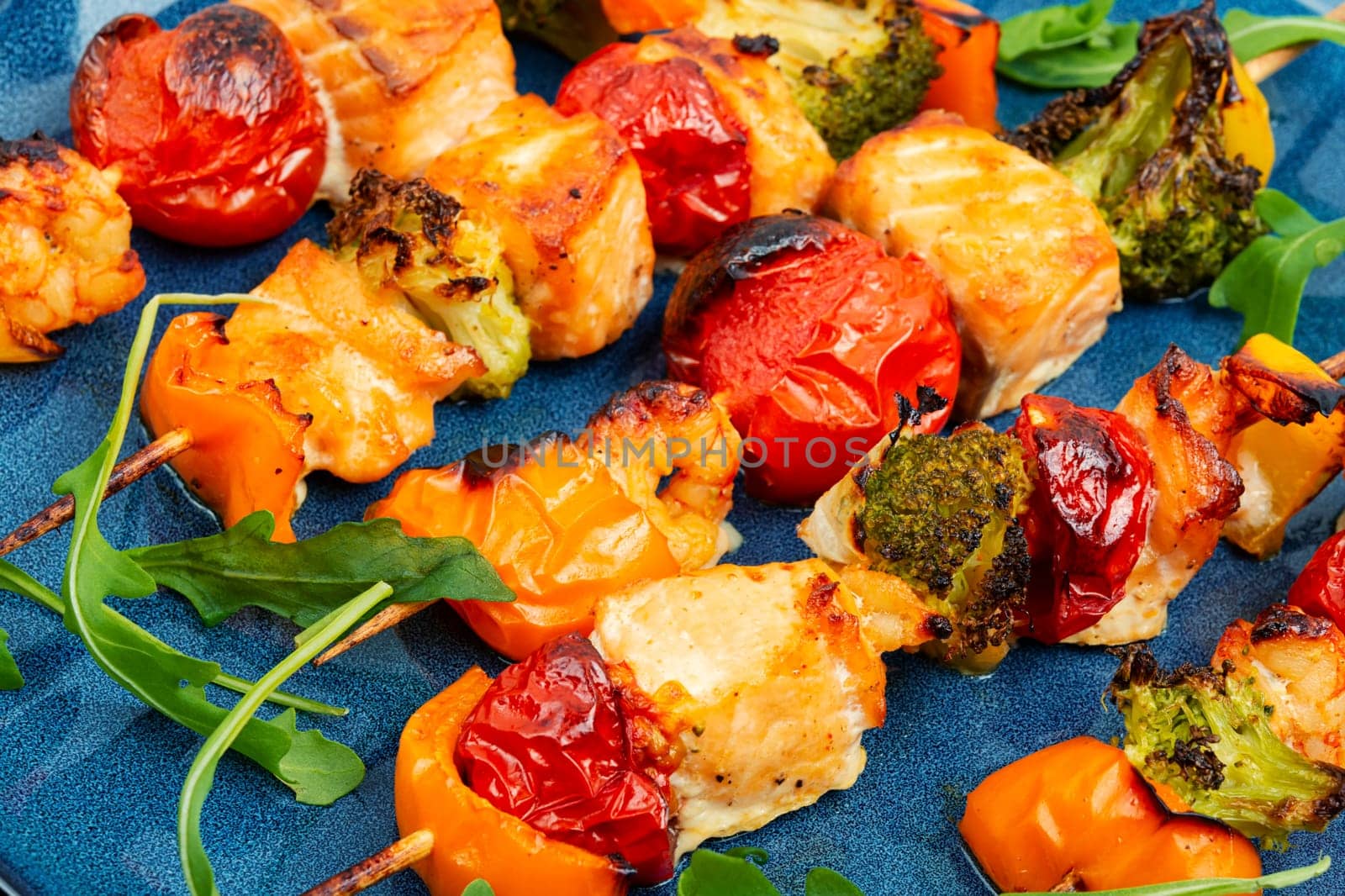 Skewers of fish salmon and vegetables on wooden stick. Seafood kebab. Copy space. Long banner.